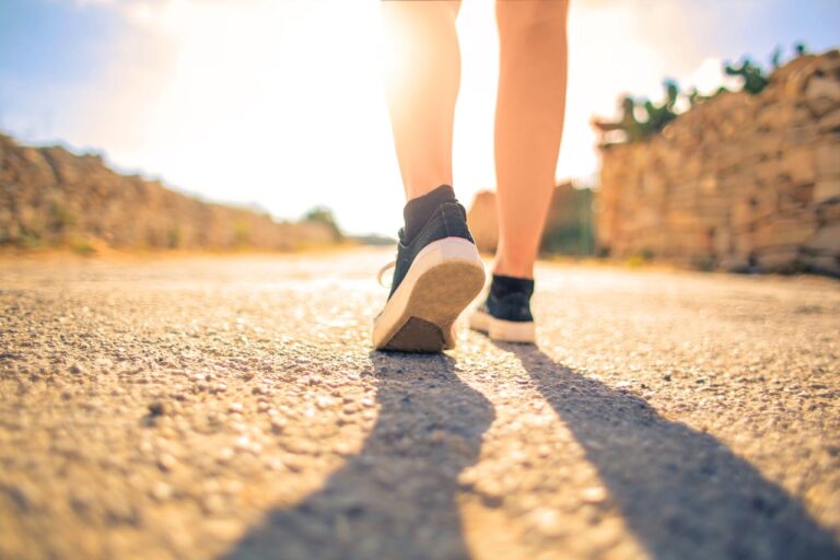 Barefoot shoes being worn by someone walking.